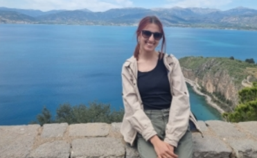 A girl posing with a beautiful view to the sea