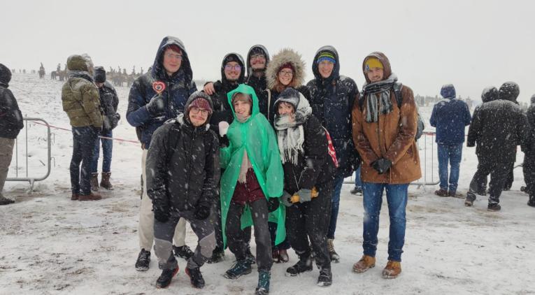 People posing during a snowstorm
