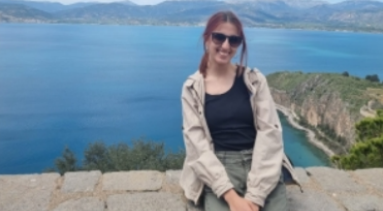 A girl posing with a beautiful view to the sea